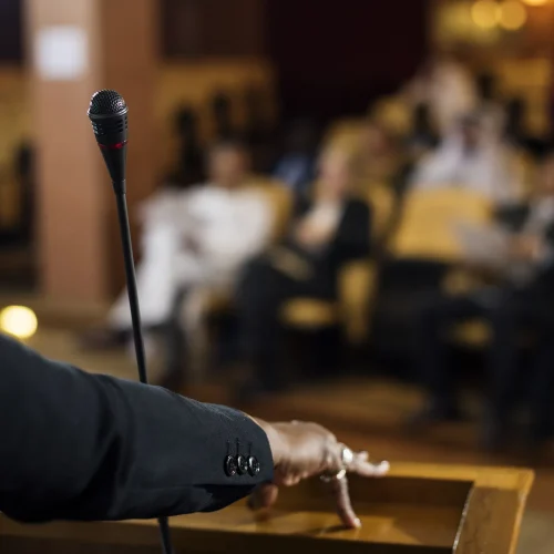 speaker-at-podium-addressing-conference-audience-2026-03-19-03-22-58-utc